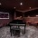 A music room with a piano and seating