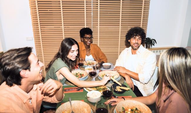 Vibrant community life with a variety of dining options a group of people sitting around a table eating food