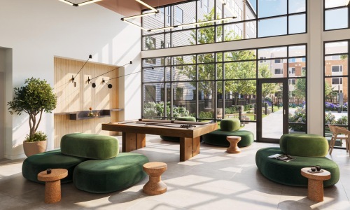 a room with green chairs and a table with a plant in it